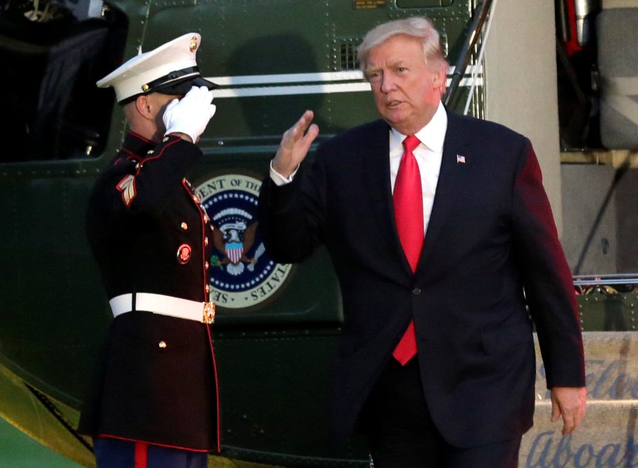 Trump askerin rüzgardan uçan şapkasını kovaladı